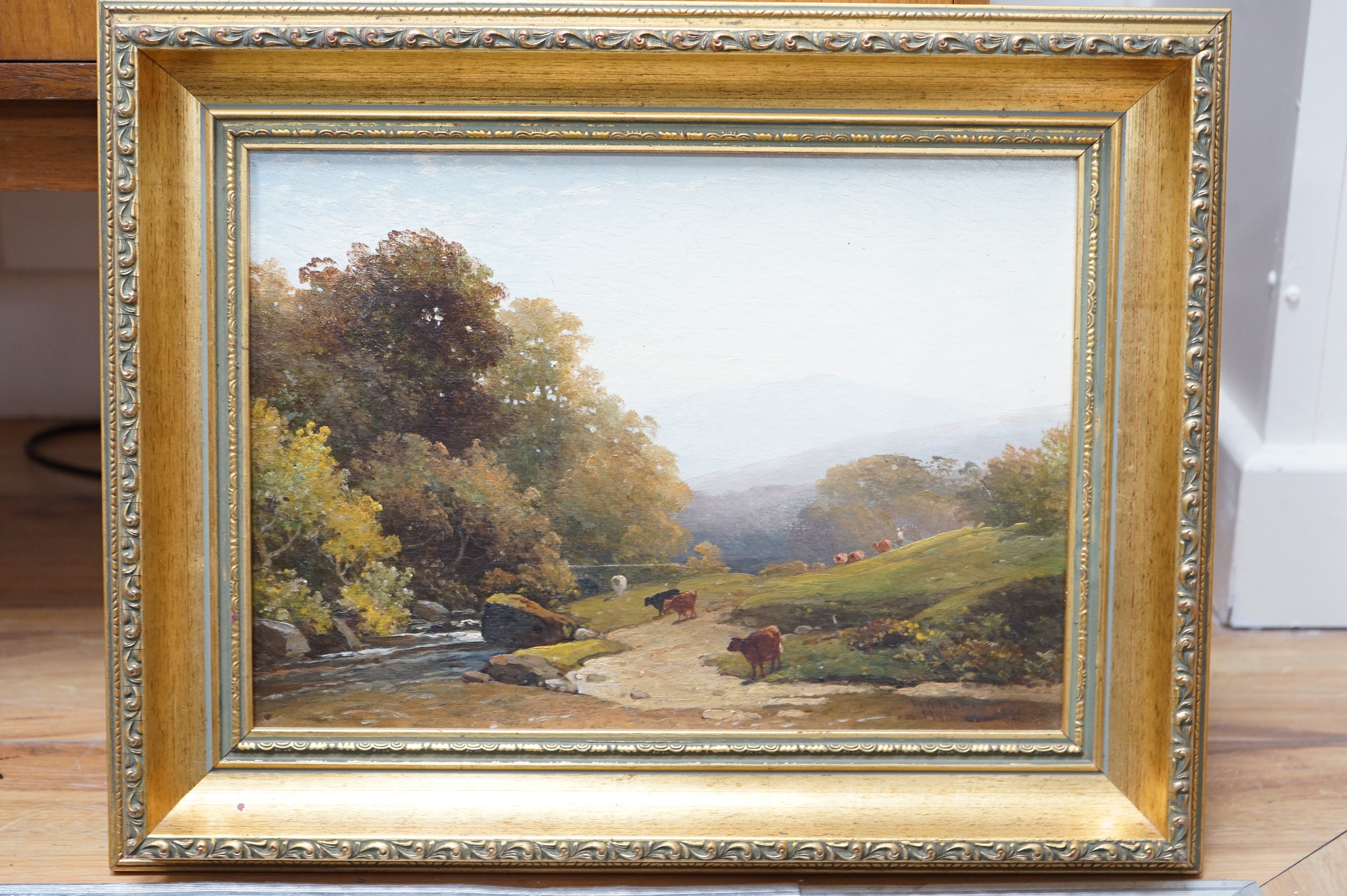 William Williams of Plymouth (1808-1895), oil on board, Riverscape with cattle grazing, signed and dated 1886, 24 x 34cm, gilt framed. Condition - fair, some craquelure throughout